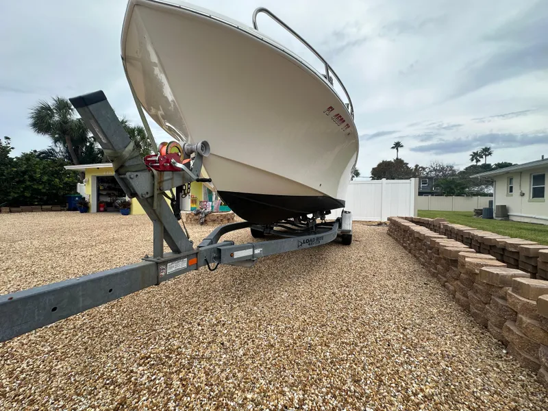 Slide: The Image of 2017 May-Craft 2300CCX boat on trailer in gravel driveway. - 45