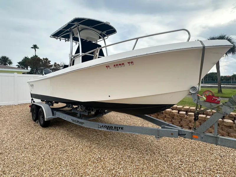 Slide: The Image of 2017 May-Craft 2300CCX boat on Load Rite trailer, parked on gravel. - 7