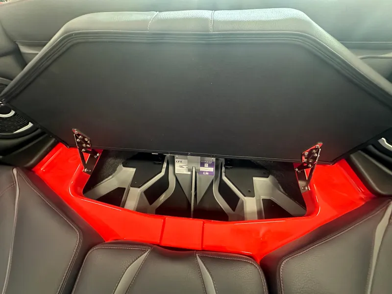 Slide: The Image of 2025 Supra SA 450 interior storage compartment with red accents and black seating. - 15