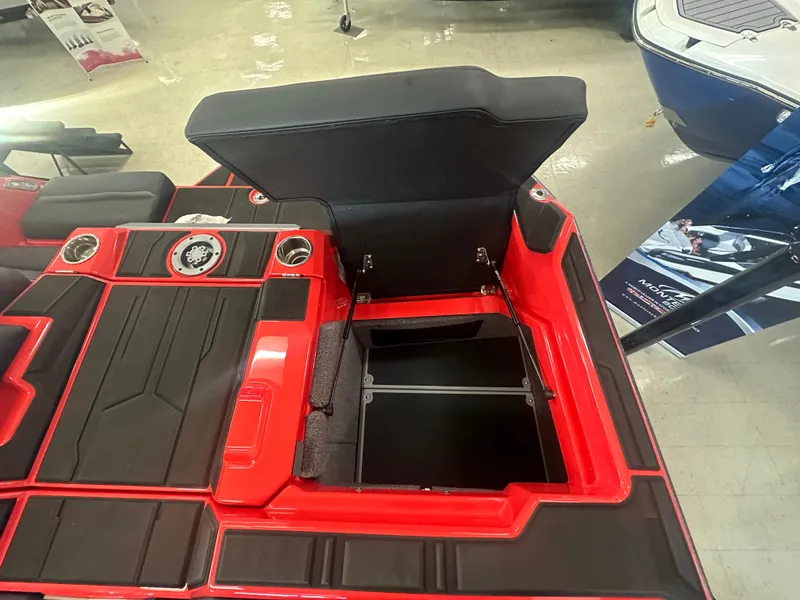 Slide: The Image of 2025 Supra SA 450 boat interior with open storage compartment and sleek red-black design. - 24