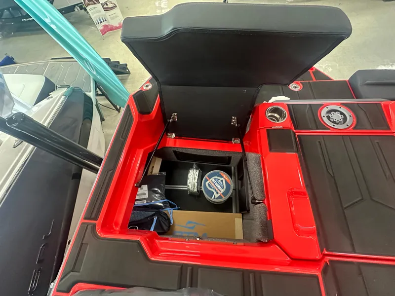 Slide: The Image of 2025 Supra SA 450 boat storage compartment with open lid, showcasing interior features. - 26