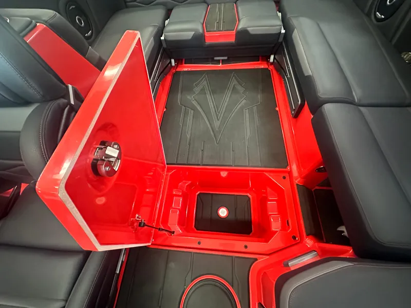 Slide: The Image of 2025 Supra SA 450 interior with red and black seating and storage compartment. - 28