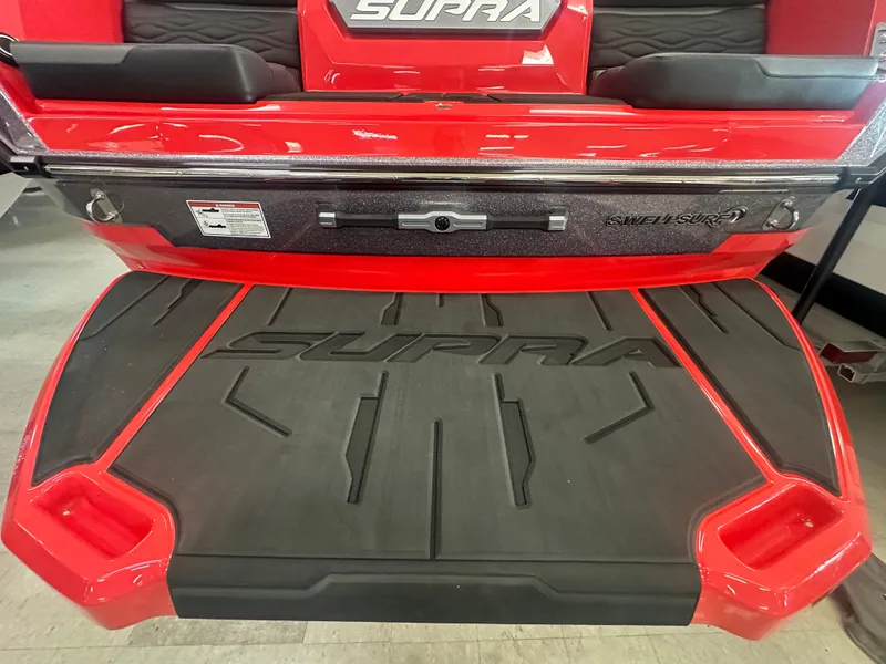 Slide: The Image of 2025 Supra SA 450 boat with red and black detailing, featuring branded swim platform. - 40