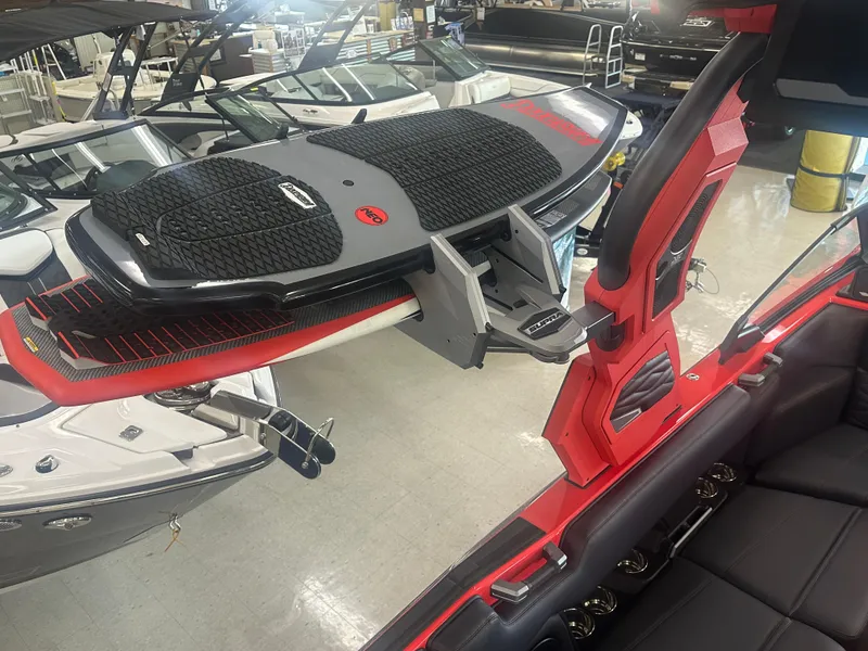 Slide: The Image of 2025 Supra SA 450 boat with wakeboard rack in showroom. - 43