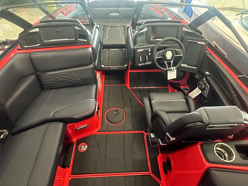 Slide: The Image of 2025 Supra SA 450 boat interior with black and red seating, modern dashboard, and steering wheel. - 44