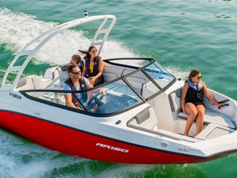Slide: The Image of 2024 Yamaha Boats AR190 cruising on water with passengers enjoying the ride. - 4