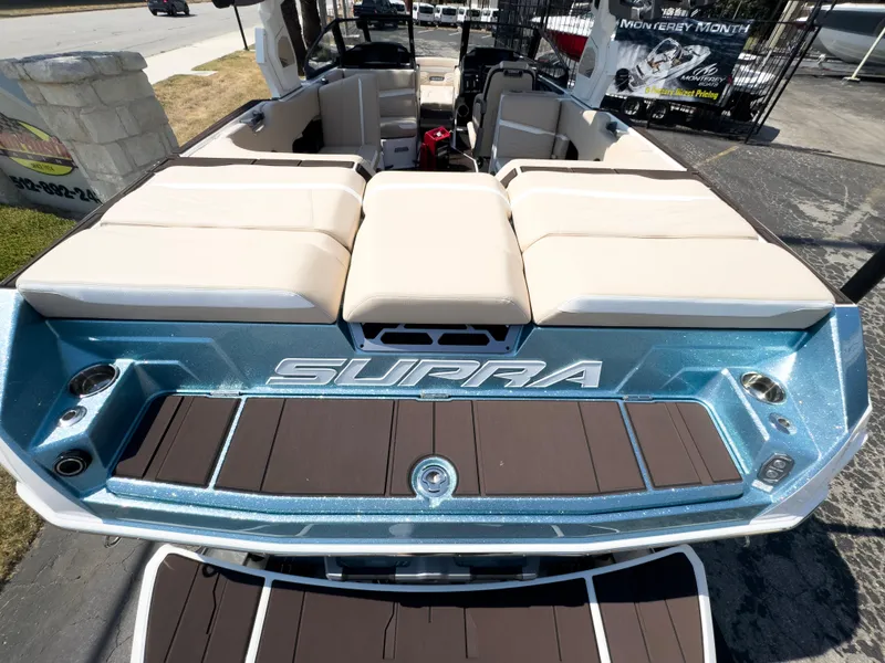 Slide: The Image of 2025 Supra SL 550 boat with beige seating and blue exterior. - 12