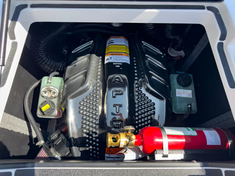 Slide: The Image of 2025 Supra SL 550 engine compartment with fire extinguisher and fluid reservoirs. - 17