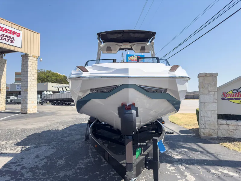 Slide: The Image of 2025 Supra SL 550 boat on trailer at dealership, front view. - 2