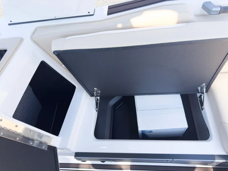 Slide: The Image of 2025 Supra SL 550 boat storage compartments with open lids. - 21