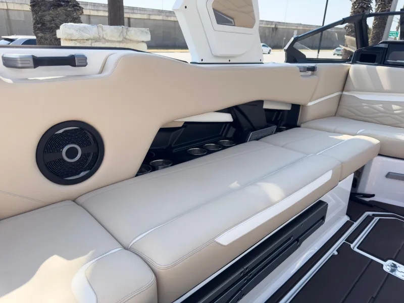 Slide: The Image of 2025 Supra SL 550 boat interior with beige seating and built-in speaker. - 23