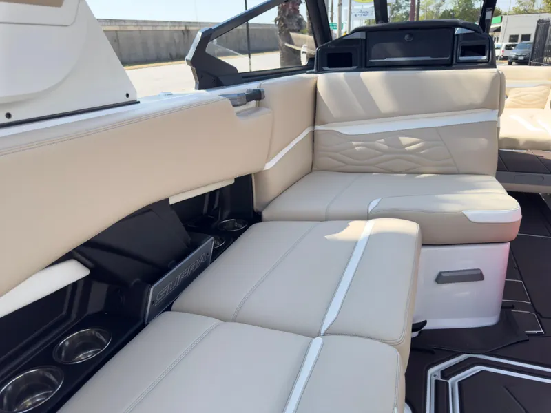 Slide: The Image of 2025 Supra SL 550 boat interior with beige leather seating and modern design. - 25