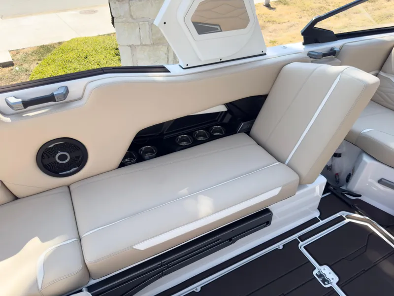 Slide: The Image of 2025 Supra SL 550 boat interior with beige seating and built-in speakers. - 26