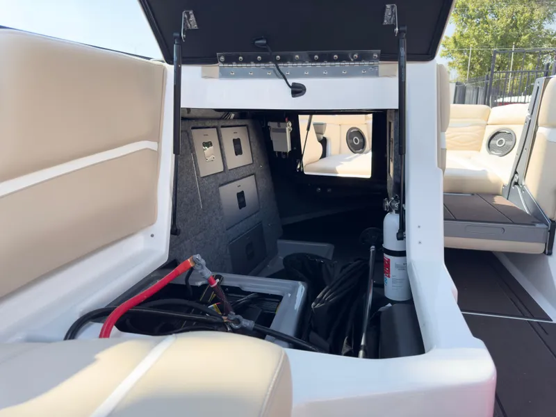 Slide: The Image of 2025 Supra SL 550 boat interior with open storage compartment and visible wiring. - 28