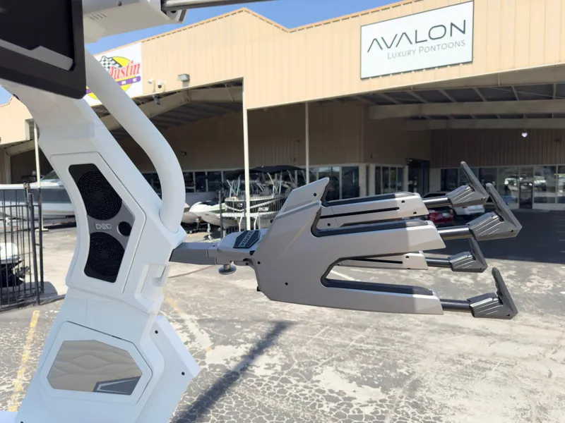 Slide: The Image of 2025 Supra SL 550 boat with wakeboard racks at Avalon Luxury Pontoons dealership. - 32