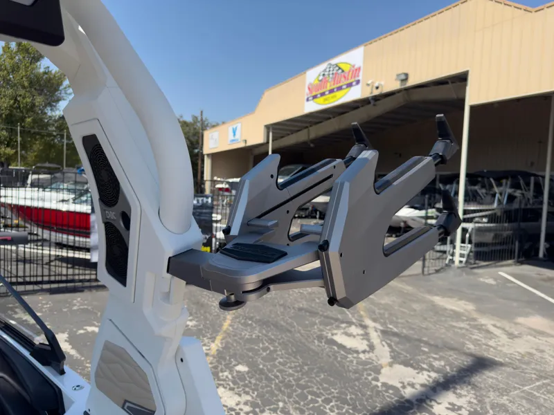 Slide: The Image of 2025 Supra SL 550 boat tower with wakeboard rack in marina setting. - 34