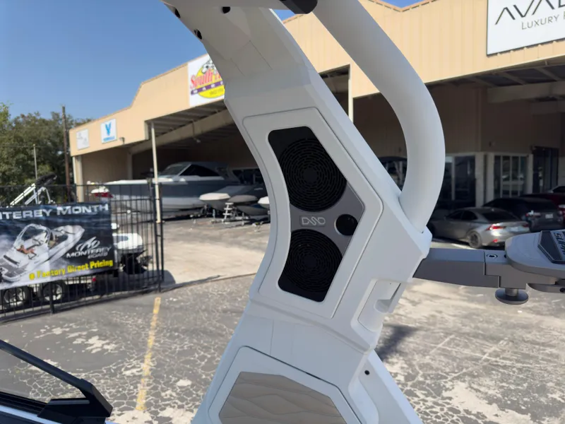 Slide: The Image of 2025 Supra SL 550 boat tower with speakers in a dealership lot. - 36