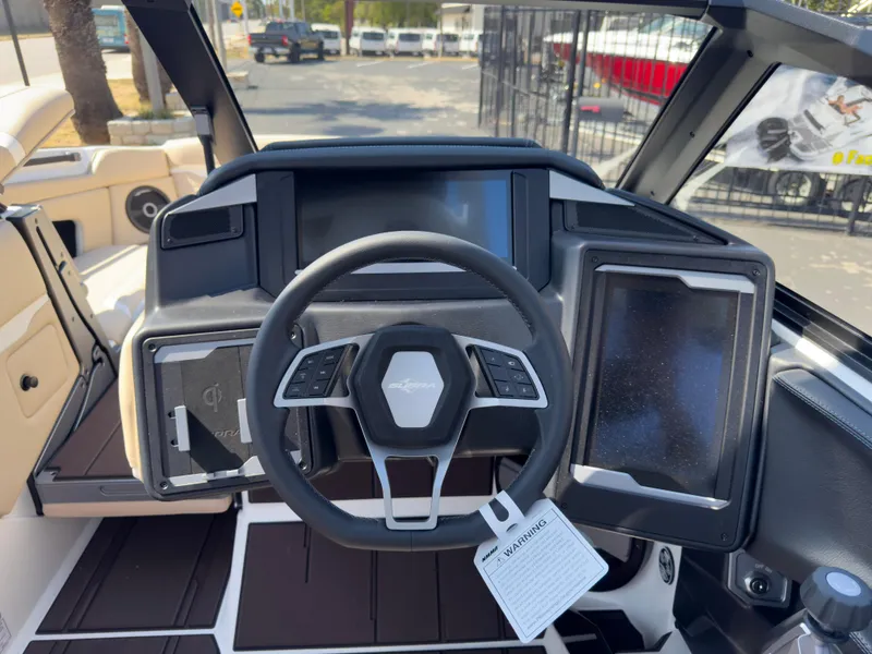 Slide: The Image of 2025 Supra SL 550 boat dashboard with steering wheel and digital displays. - 40
