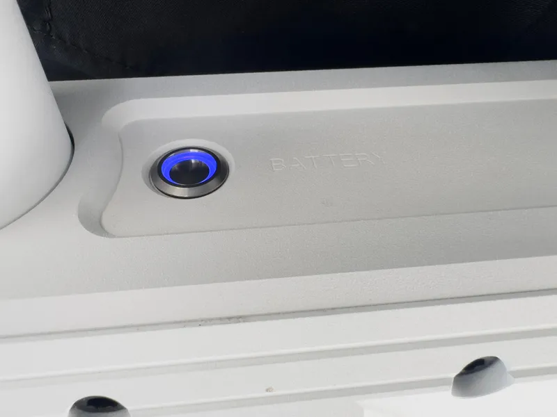 Slide: The Image of Close-up of 2025 Supra SL 550 battery compartment with blue power button. - 41