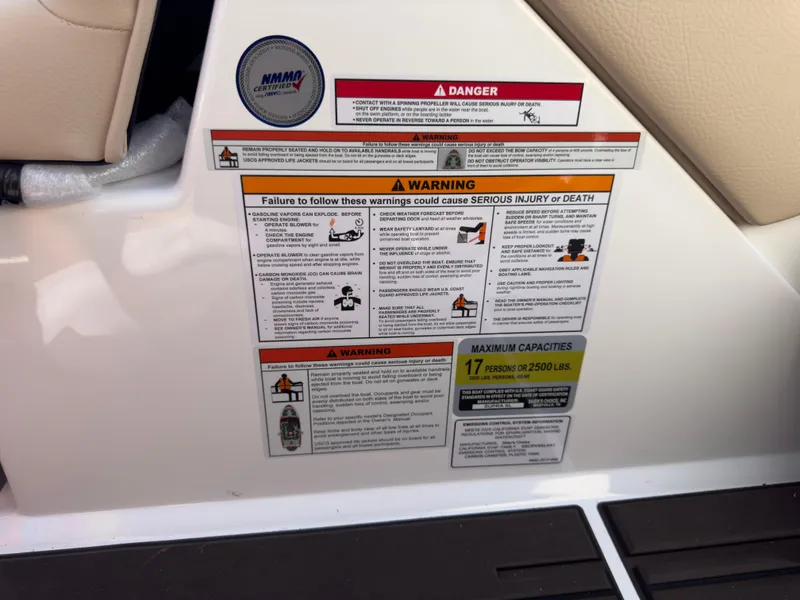 Slide: The Image of Warning labels on 2025 Supra SL 550 boat, highlighting safety and capacity information. - 49