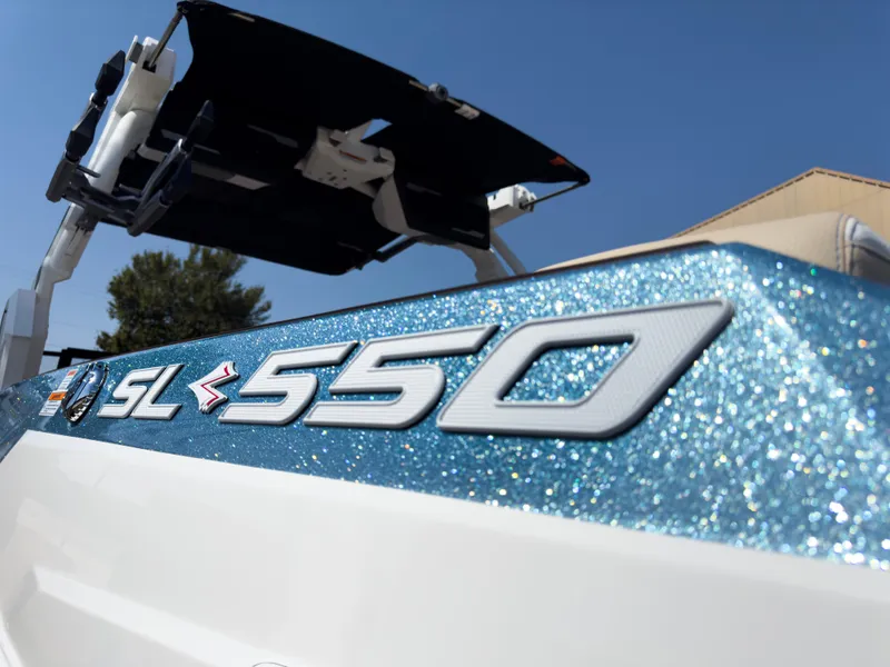 Slide: The Image of 2025 Supra SL 550 boat with glittery blue finish and sleek design. - 8