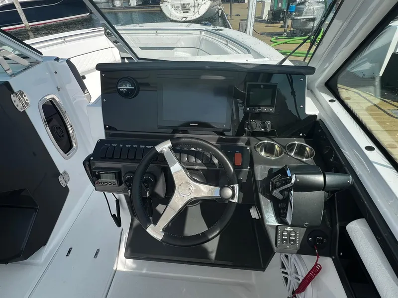 Slide: The Image of 2023 Blackfin 272 DC boat helm with steering wheel and control panel. - 13