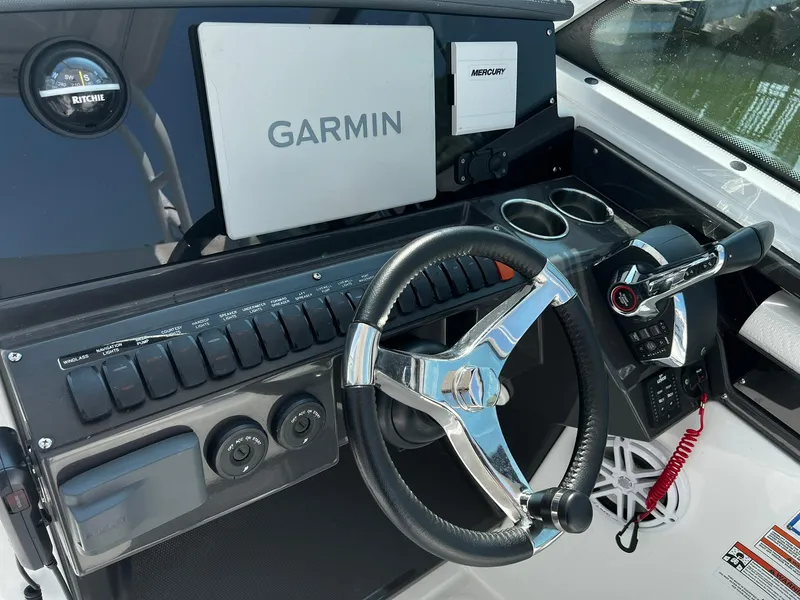 Slide: The Image of 2023 Blackfin 272 DC boat dashboard with Garmin navigation and Mercury controls. - 14