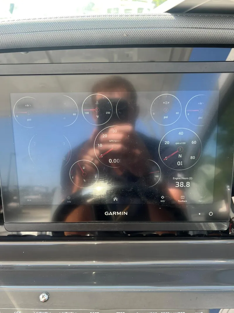Slide: The Image of Garmin display on 2023 Blackfin 272 DC boat dashboard, showing various gauges and reflections. - 16