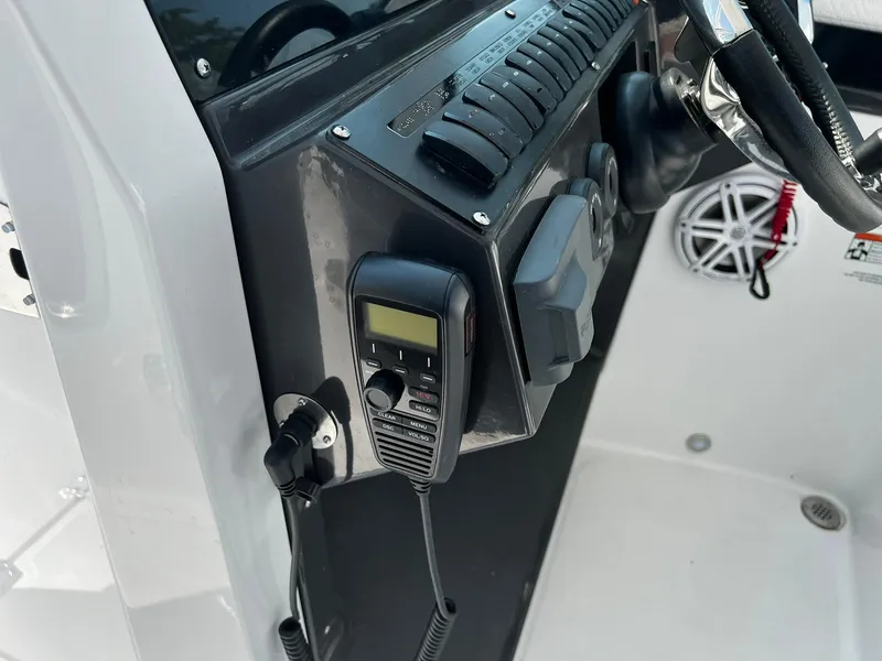 Slide: The Image of 2023 Blackfin 272 DC boat dashboard with radio and controls. - 17