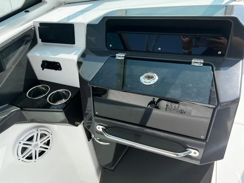 Slide: The Image of 2023 Blackfin 272 DC boat dashboard with storage compartment and cup holders. - 19