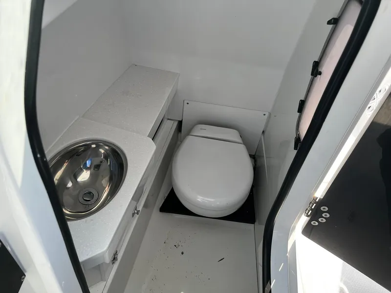 Slide: The Image of 2023 Blackfin 272 DC boat interior with toilet and sink. - 21