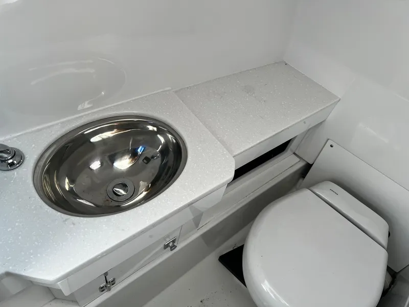 Slide: The Image of 2023 Blackfin 272 DC boat bathroom with stainless steel sink and toilet. - 22