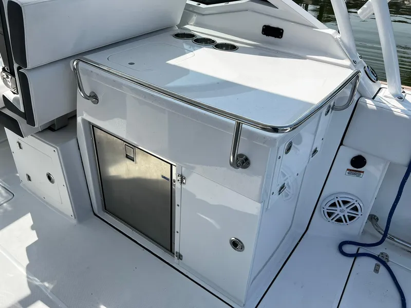 Slide: The Image of 2023 Blackfin 272 DC boat interior with stainless steel fixtures and storage compartment. - 24