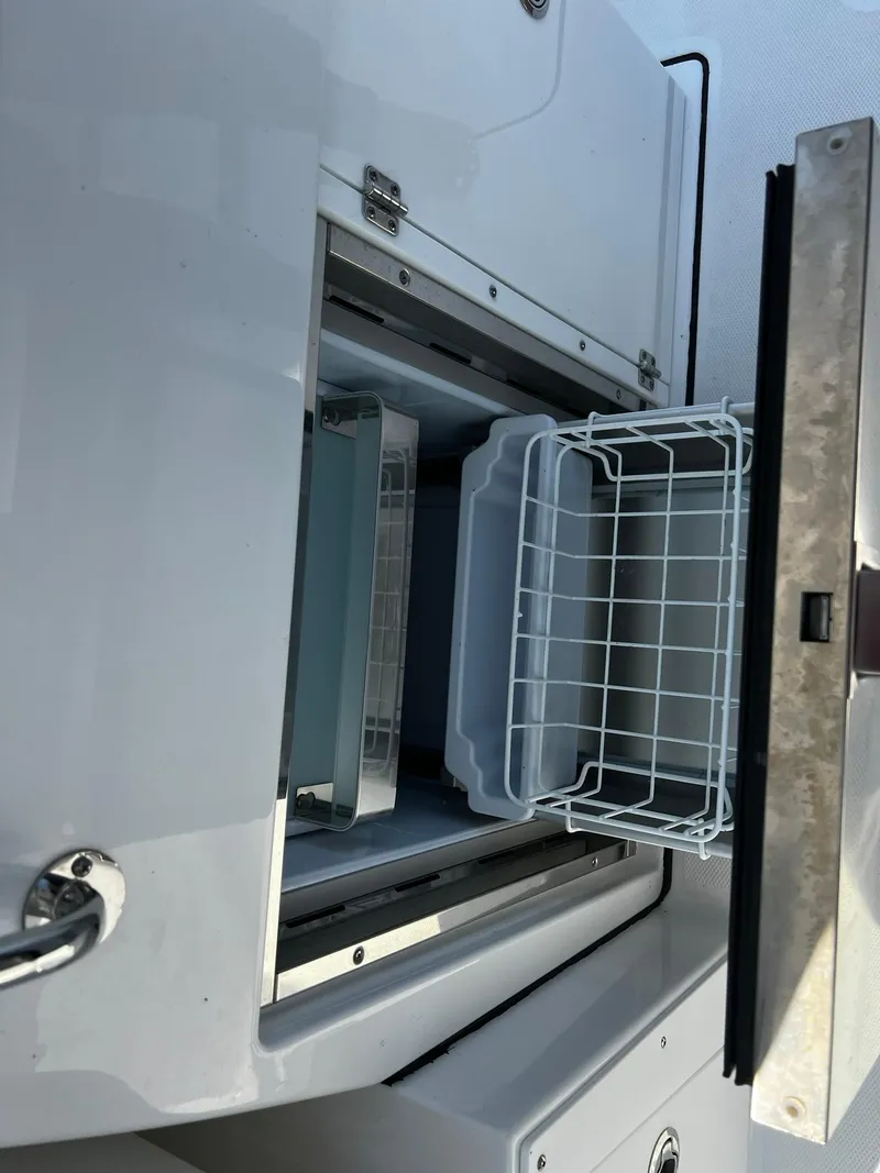 Slide: The Image of 2023 Blackfin 272 DC boat storage compartment with open sliding drawer. - 26