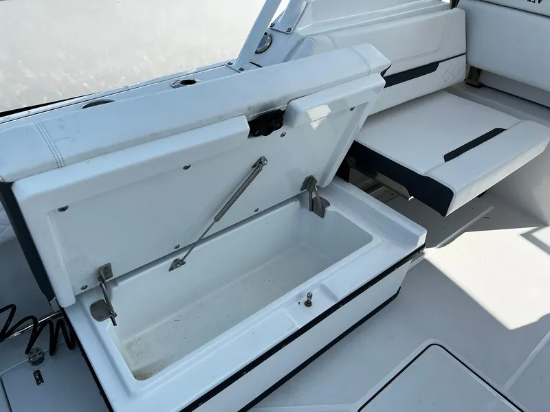 Slide: The Image of 2023 Blackfin 272 DC boat interior with open storage compartment and seating. - 27