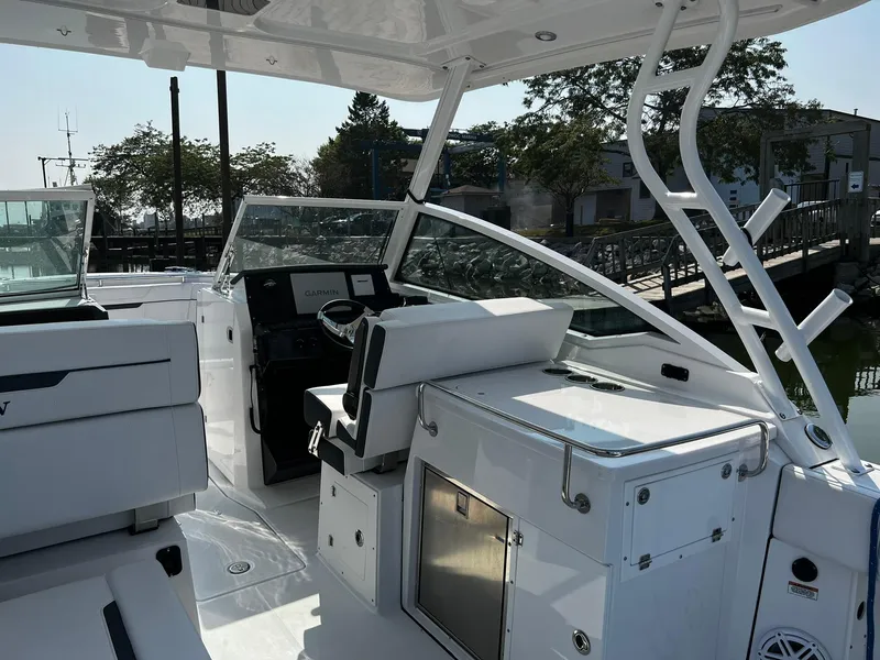 Slide: The Image of 2023 Blackfin 272 DC boat interior with sleek seating and modern controls. - 31