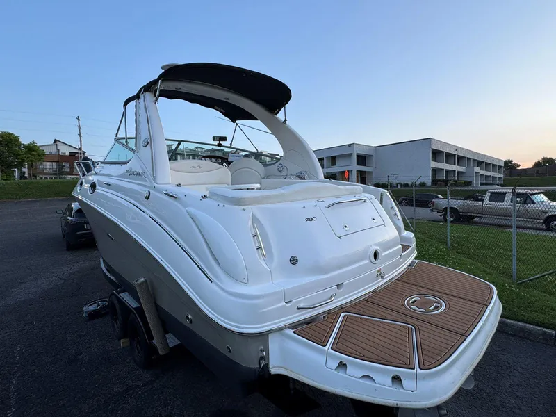 Slide: The Image of 2006 Sea Ray 280 Sundancer boat with sleek design, docked outdoors at sunset. - 10