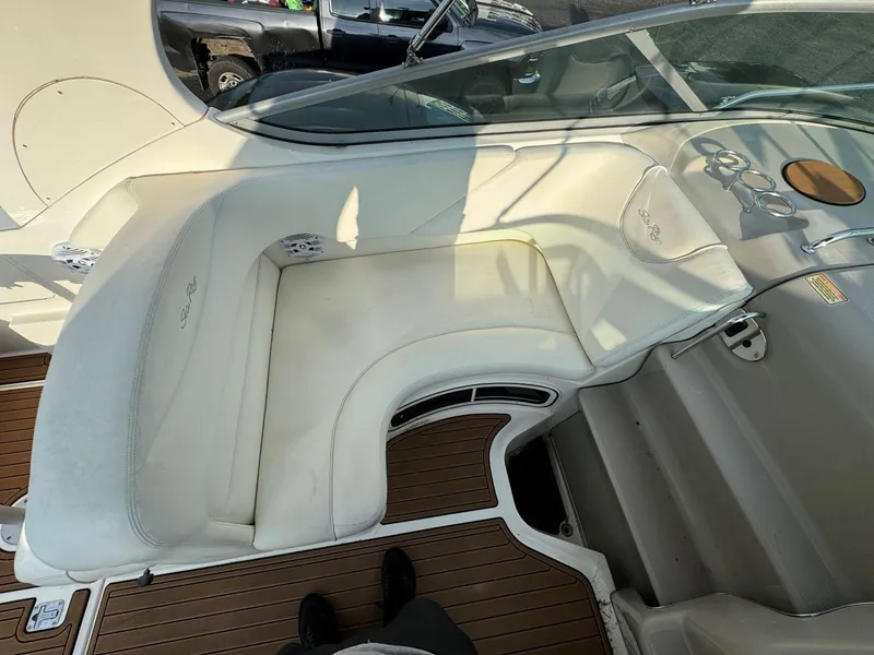 Slide: The Image of 2006 Sea Ray 280 Sundancer interior with white seating and wood flooring. - 15