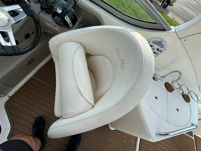 Slide: The Image of Captain's seat on 2006 Sea Ray 280 Sundancer boat, featuring white upholstery and helm controls. - 17