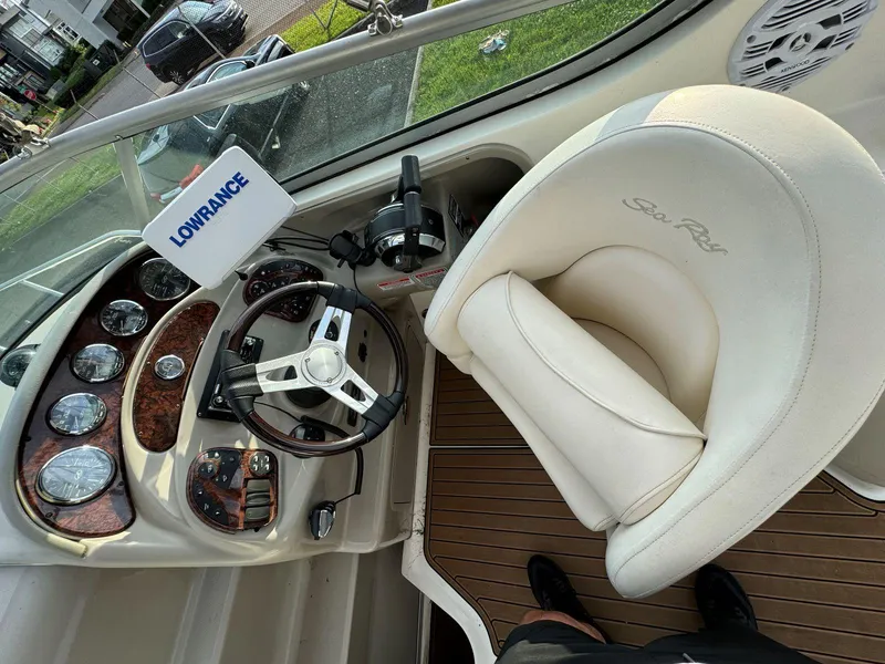 Slide: The Image of 2006 Sea Ray 280 Sundancer helm with Lowrance navigation system and plush captain's chair. - 18