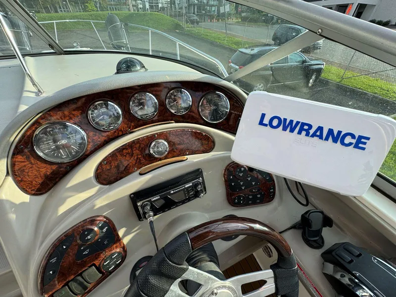 Slide: The Image of 2006 Sea Ray 280 Sundancer dashboard with Lowrance navigation system. - 19