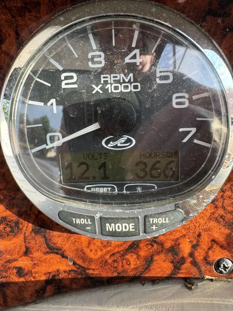 Slide: The Image of Close-up of a 2006 Sea Ray 280 Sundancer RPM gauge displaying 121 volts and 366 hours. - 21