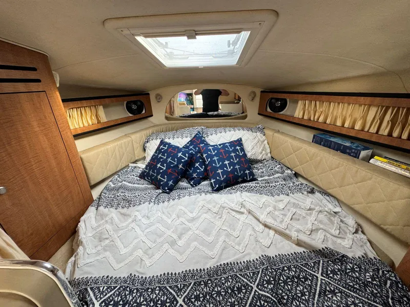 Slide: The Image of Cozy cabin interior of 2006 Sea Ray 280 Sundancer with nautical-themed bedding. - 23
