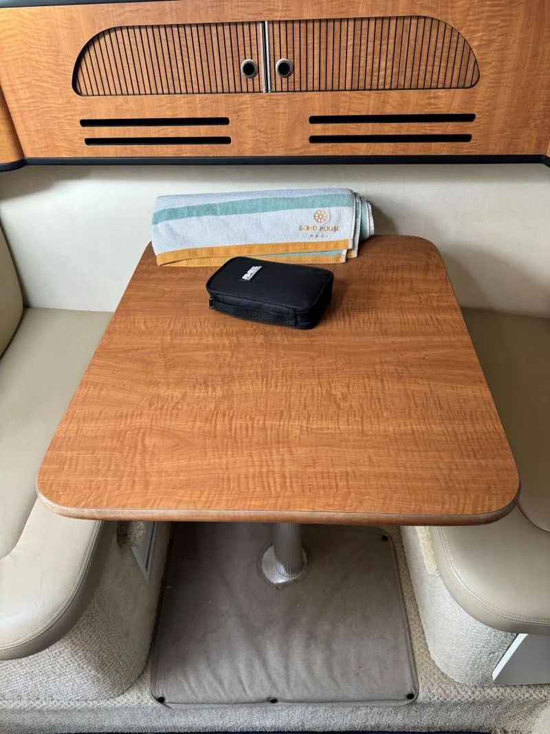 Slide: The Image of 2006 Sea Ray 280 Sundancer cabin table with seating and storage. - 25