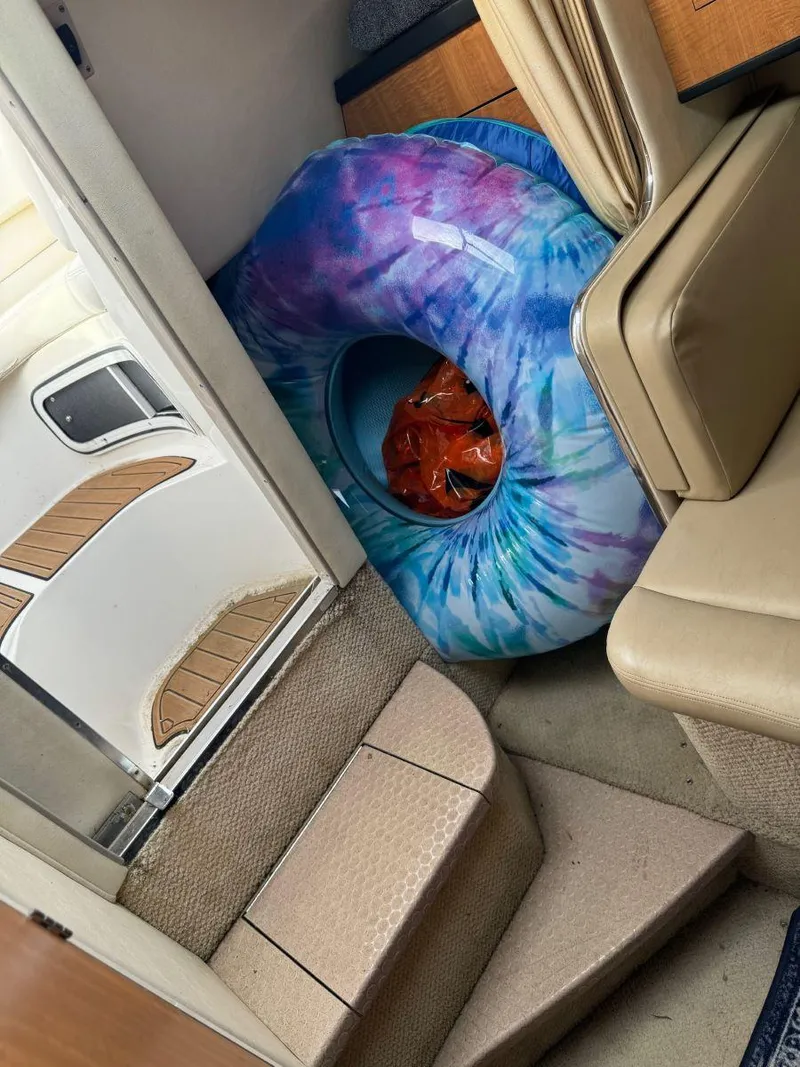 Slide: The Image of Interior of 2006 Sea Ray 280 Sundancer with colorful inflatable ring on stairs. - 29