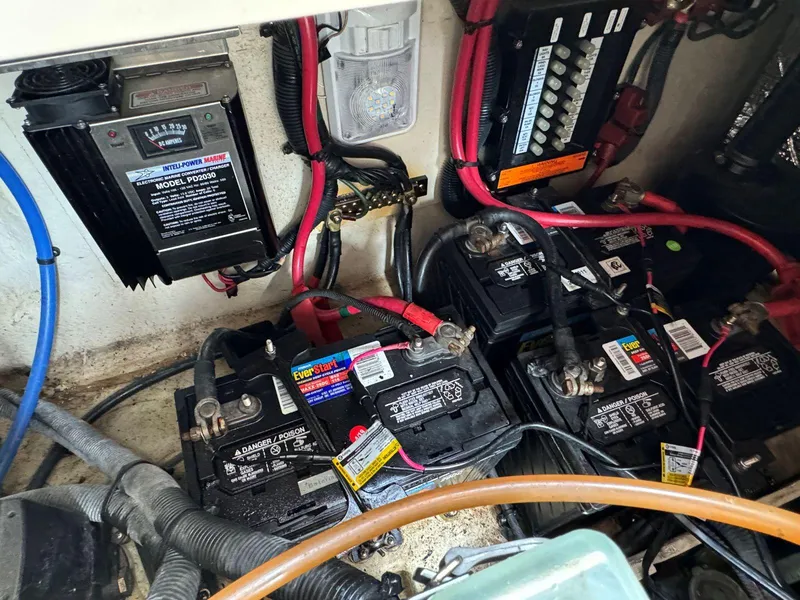 Slide: The Image of Battery compartment of a 2006 Sea Ray 280 Sundancer with wiring and power components. - 33