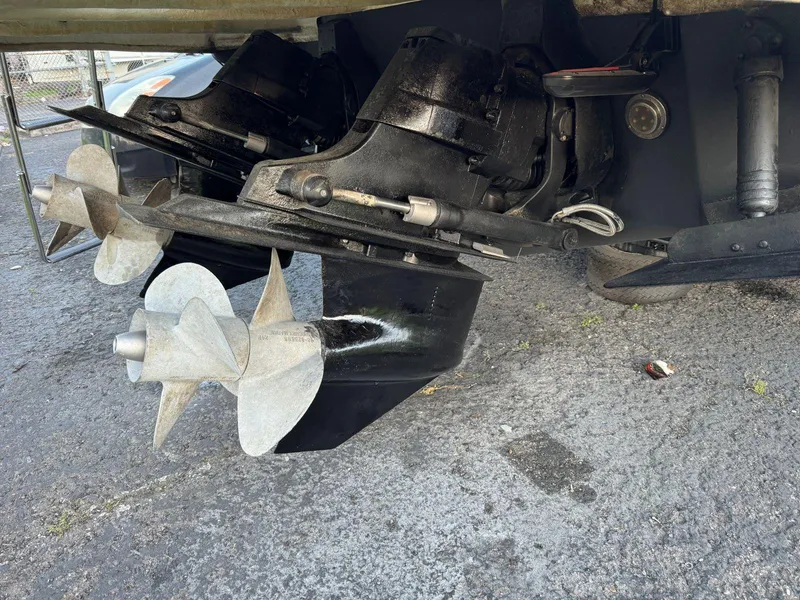 Slide: The Image of 2006 Sea Ray 280 Sundancer boat propellers and outdrives on pavement. - 34