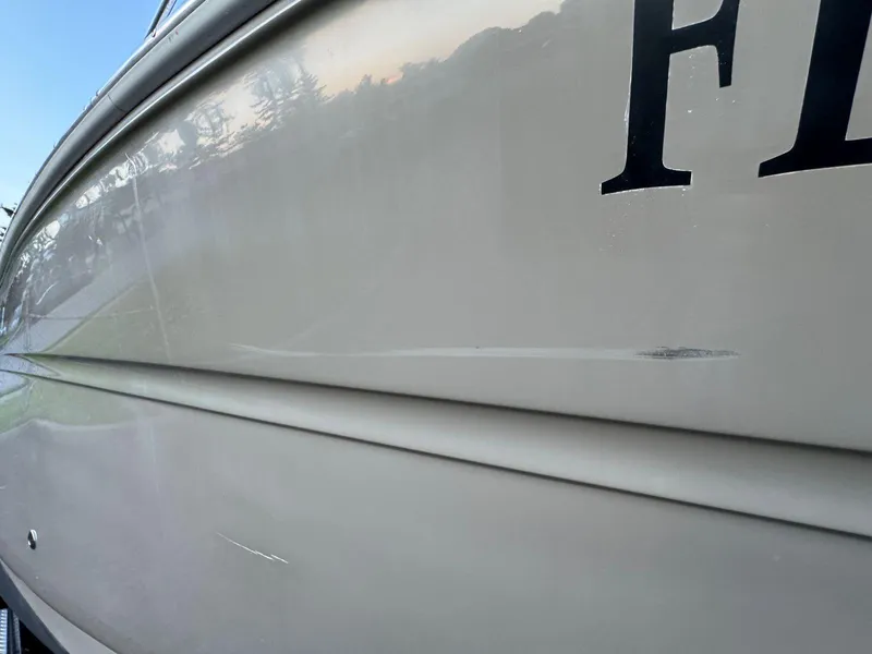 Slide: The Image of Close-up of 2006 Sea Ray 280 Sundancer boat hull with visible scratch. - 45