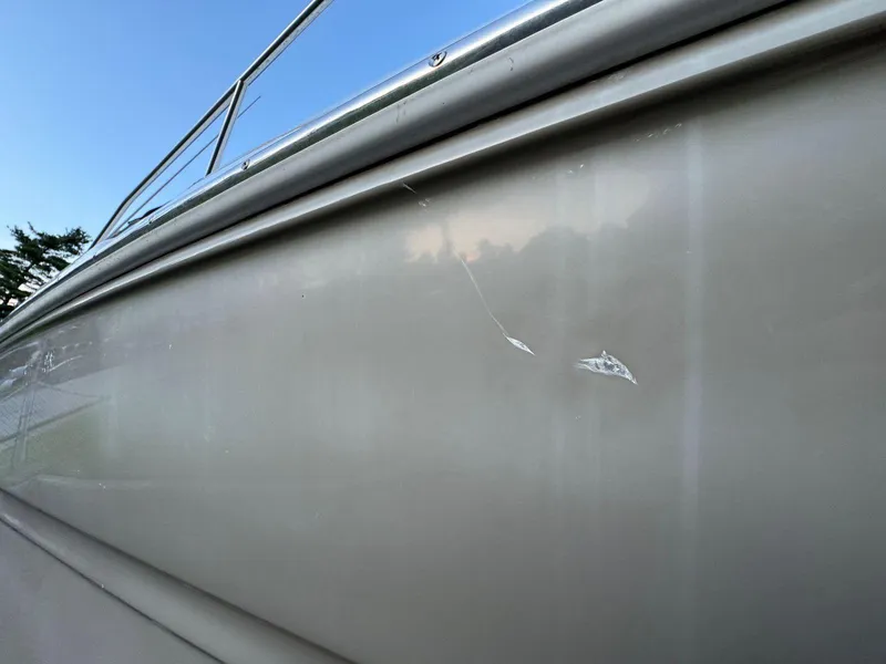 Slide: The Image of Close-up of 2006 Sea Ray 280 Sundancer with visible hull scratches. - 46