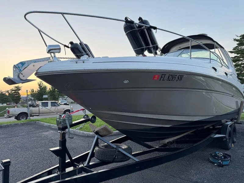 Slide: The Image of 2006 Sea Ray 280 Sundancer boat on trailer, parked outdoors at sunset. - 7